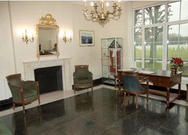 Picture of St. Mihiel American Cemetery's reception room in 2017 before the historic furnishing project. Credit: American Battle Monuments Commission. 