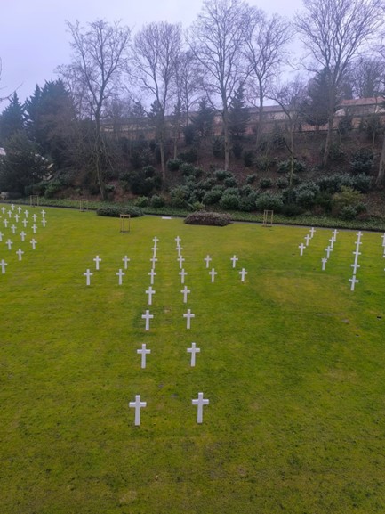 Picture of Plot D at Suresnes American Cemetery showing a cross from the sky. Credits: American Battle Monuments Commission.