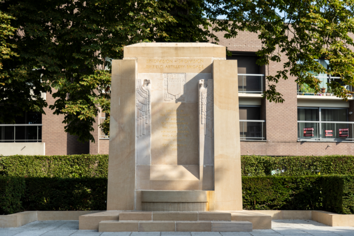Audenarde Monument close shot with some buildings behind on a sunny day.