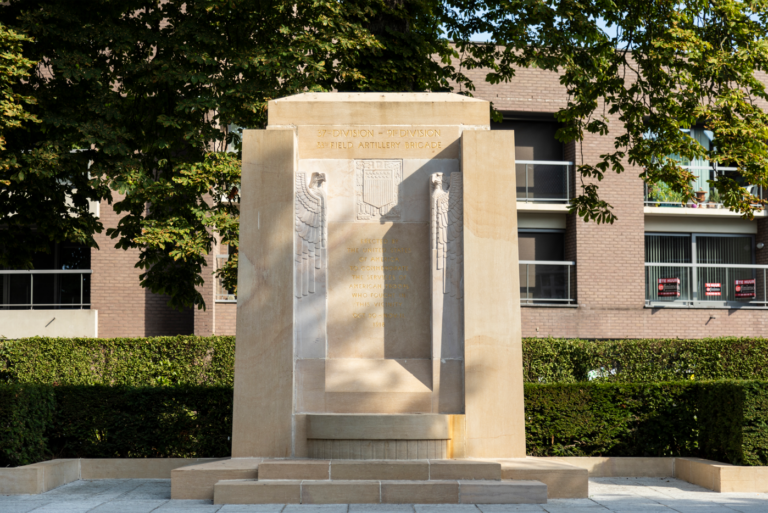 Audenarde Monument close shot with some buildings behind on a sunny day.