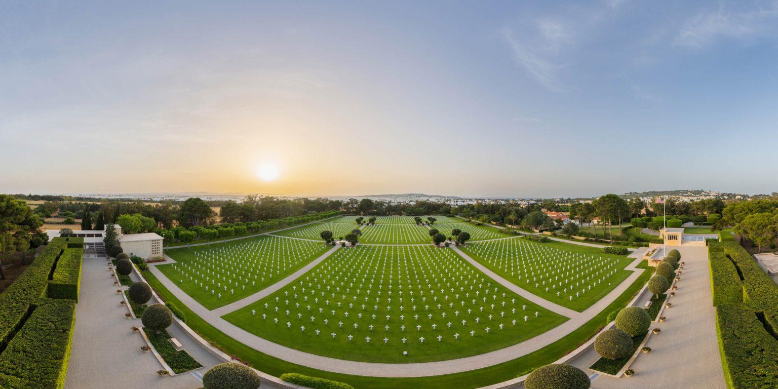 Picture of North Africa American Cemetery with the headstones and the flagpole. Credit: American Battle Monuments Commission/ Robert Uth. 