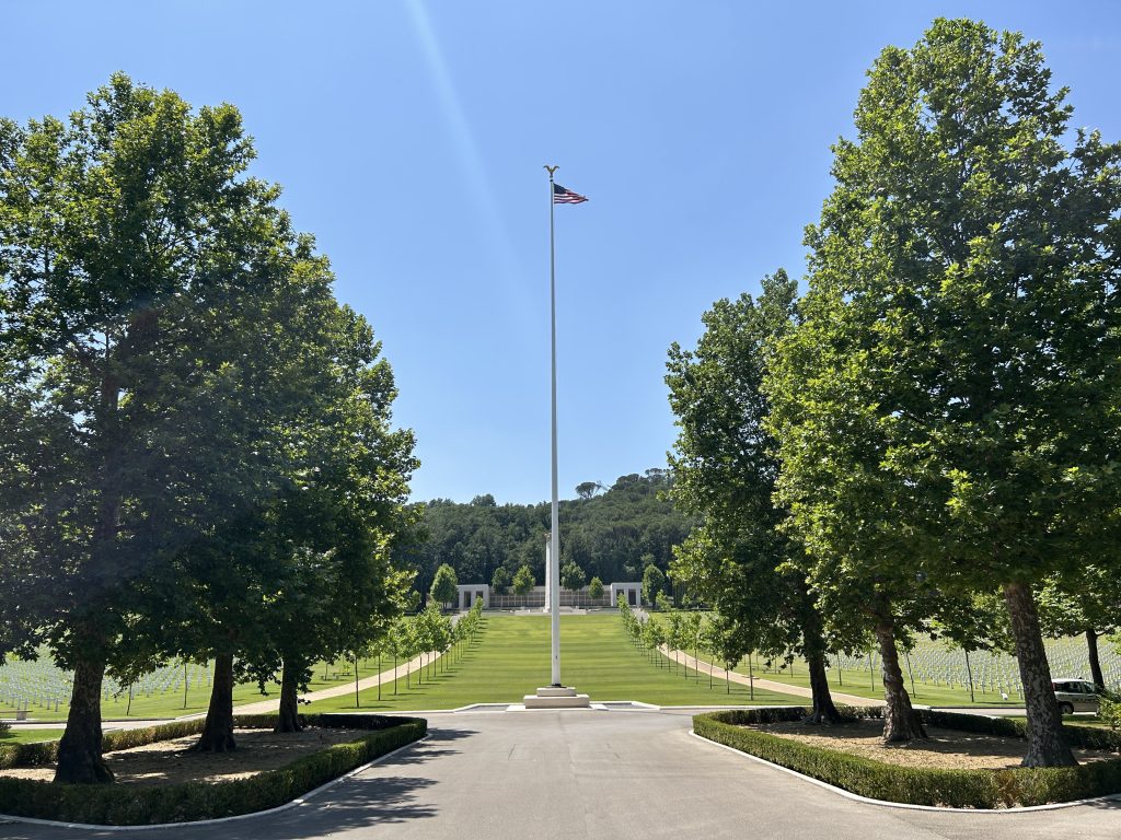 The U.S. flag traveling for the Flag Sojourn 250 flies over Florence American Cemetery in Italy. (American Battle Monuments Commission photo)