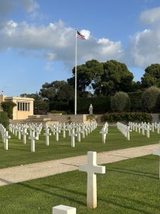 The U.S. flag traveling for the Flag Sojourn 250 flies over North Africa American Cemetery.