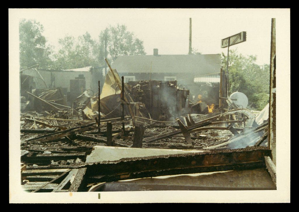Rubble remains of building still burning in the wake of Hurricane Camille, August 18, 1969