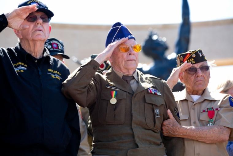 WWII veterans salute as taps is played during the 70th French-American Commemoration D-Day Ceremony at the Normandy American Cemetery and Memorial in Colleville-sur-Mer