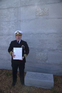 Dru DiMattia, president of the American Merchant Marine Veterans stands next to the new marker at the base of the West Coast Memorial May 22, 2025, honoring U.S. Merchant Marines.