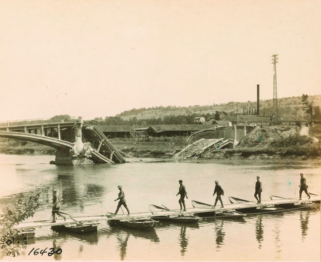Soldiers en route to the front cross a pontoon bridge across the Marne.