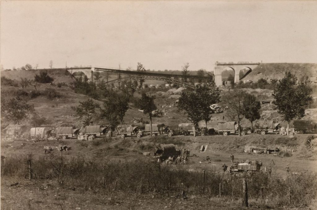 A damaged bridge at Flirey creates a traffic jam of trucks in the foreground.