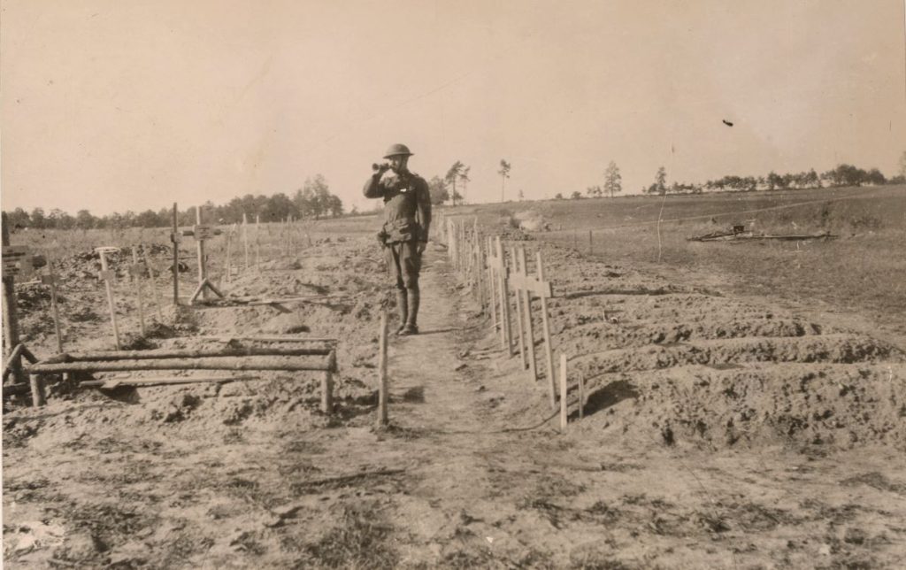 An American bugler blowing the last call at the graves of American soldiers at the temporary cemetery at St. Mihiel.