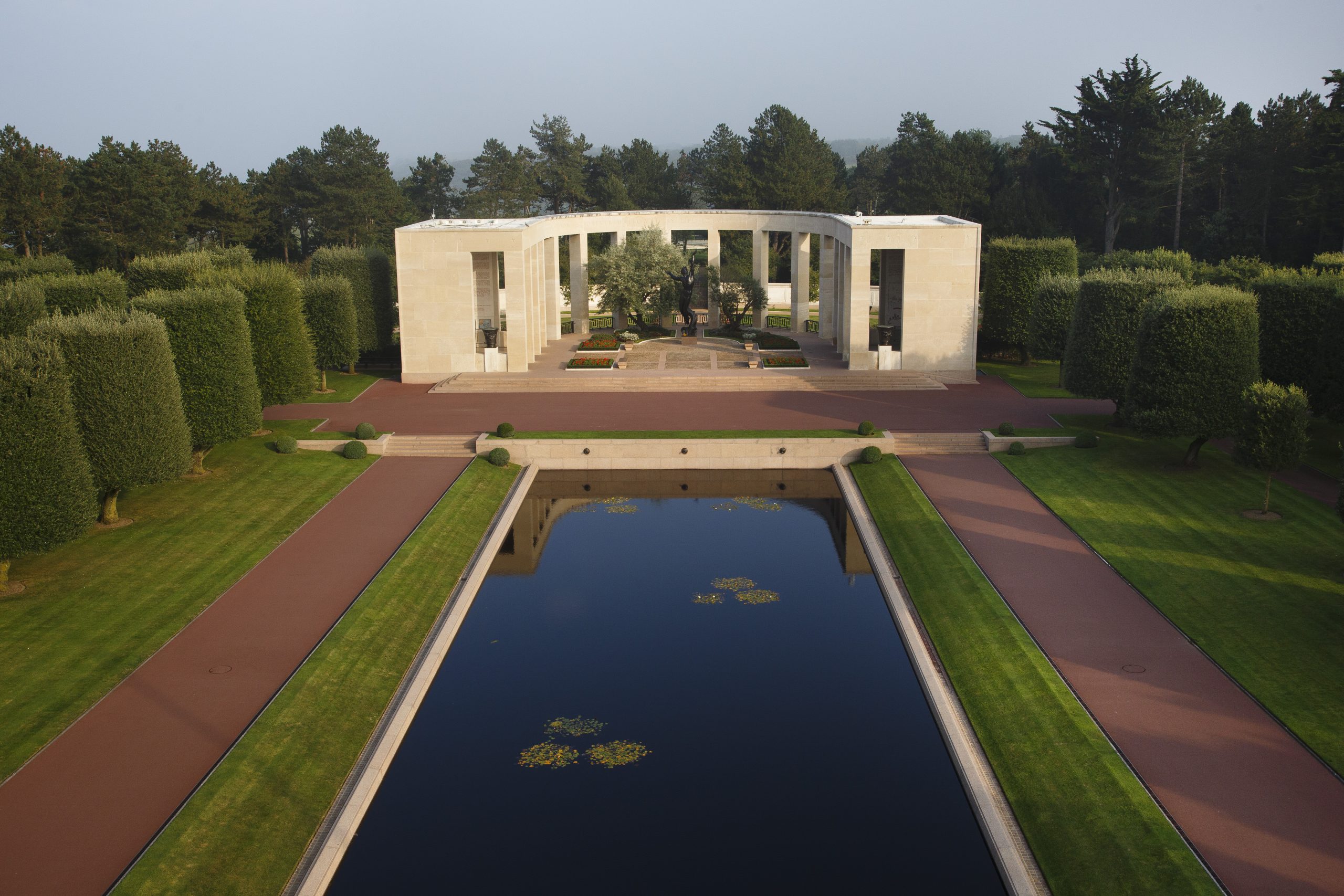 Picture of Normandy American Cemetery with one U.S. flag and the headstones. Credit: American Battle Monuments Commission/ Robert Uth.